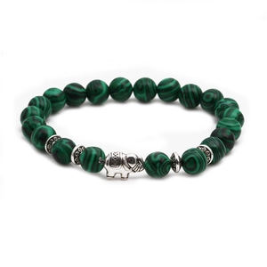 Detailed shot of malachite beads and silver elephant charm on a boho style bracelet