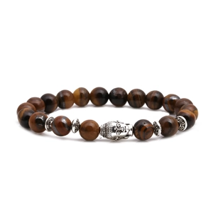 Detailed macro view of tiger eye beads with silver Buddha head and textured spacers