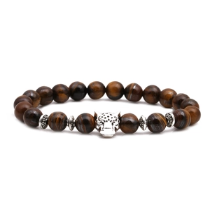 Macro shot of tiger eye stone beads bracelet with a silver leopard head and spacer beads