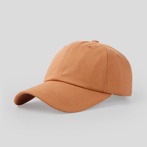 Close-up of caramel brown cotton baseball cap showing 6-panel stitching and curved brim