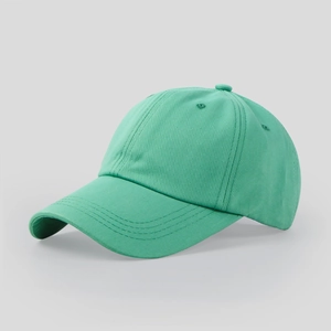 Detail of mint green baseball cap showing curved brim stitching and cotton fabric texture
