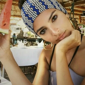 Detailed view of wide blue wavy headband paired with large gold hoop earrings on model