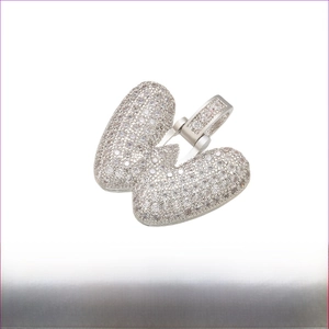 Macro view of rhodium plated brass letter W pendant with micro paved cubic zirconia