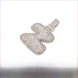Detailed view of pavé set crystal 'K' letter pendant in silver finish with dimensions