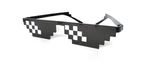 Close-up of black pixel-style Thug Life sunglasses for party and video props