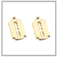 Macro shot of two golden stainless steel razor blade pendants for DIY jewelry making