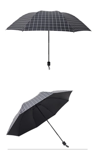 Detail of black plaid folding umbrella with UV protection coating and sturdy frame