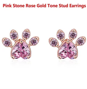 Close-up of heart-shaped pink gem cat paw stud earrings in rose gold finish