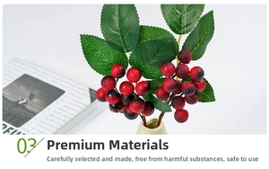 Close-up of artificial red berry branches with gradient textures in a ceramic vase