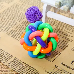 Detailed close-up of a multi-colored woven pet ball with an internal metallic bell