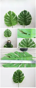 Close-up of artificial Monstera leaf with natural green texture and long stem for home decor