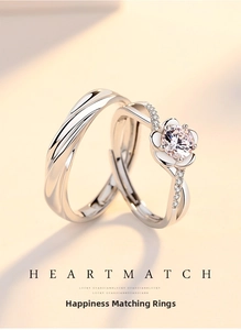 Detailed macro view of adjustable silver couple rings with flower and wave texture patterns