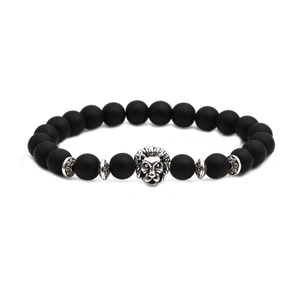 Close-up of matte black agate beaded bracelet featuring a detailed silver lion head charm