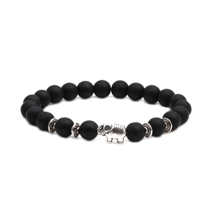 Detail of matte black agate beads bracelet featuring a silver elephant charm and spacers