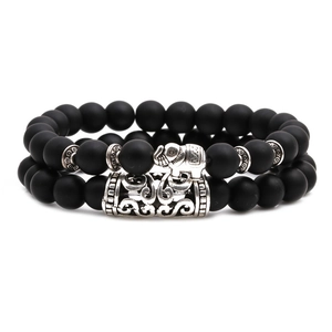 Detail of matte black agate beads with silver elephant charm and hollow metal tube charm
