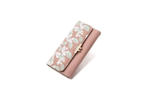 Detail view of pink trifold wallet featuring floral pattern and golden ball clasp