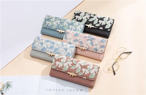 Detailed view of floral PU leather long wallets with elegant metal bar snap closure