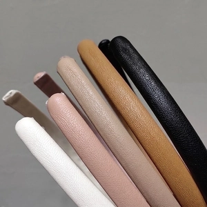 Minimalist leather hairbands in multiple earth tones with textured lychee grain finish