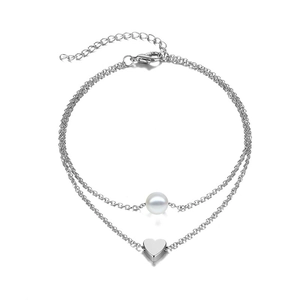 Detail of silver double-layer anklet featuring a heart pendant and a white pearl bead