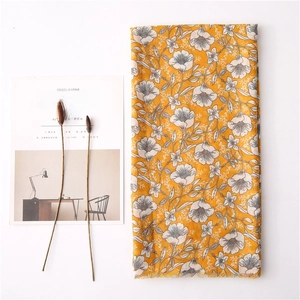Lightweight ginger yellow floral cotton linen scarf with white gardenia print on white background