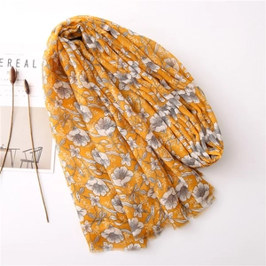 Yellow floral cotton linen scarf with gardenia print and fringe edges on white background