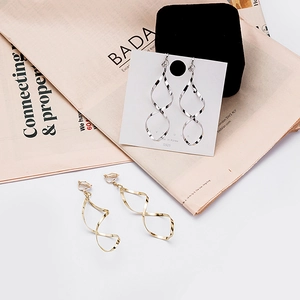 Detailed view of spiral twist earrings in gold and silver finish on S925 display card
