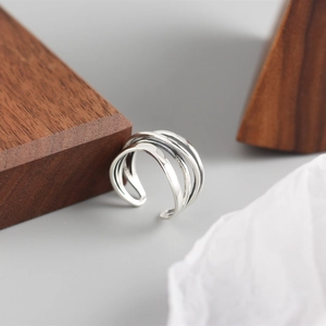 Macro shot of silver layered winding lines on an adjustable S925 sterling silver ring