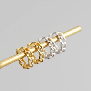 Macro shot of S925 sterling silver chain earrings in gold and silver finishes