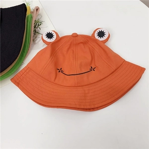Detail of cute orange frog bucket hat with 3D eyes and various color options on the side