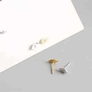 Macro shot of minimalist S925 sterling silver starburst stud earrings in gold and silver