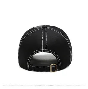 Detail of black cotton baseball cap back with white contrast stitching and bronze metal buckle