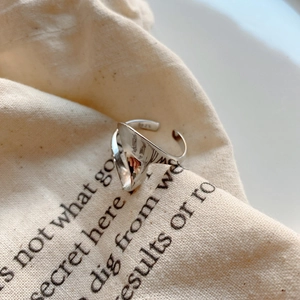 Macro shot of S925 sterling silver irregular ring showing inner hallmark and glossy texture