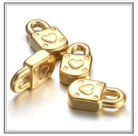 Macro shot of four golden heart-shaped padlock charms with 3D embossed heart and dot texture