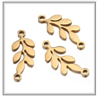 Detailed view of hollow gold leaf charms in stainless steel for DIY jewelry making