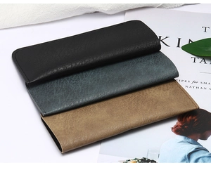 Détail de trois étuis à lunettes en similicuir haut de gamme en noir, marron et vert foncé