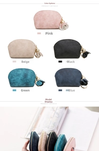 Detail view of five semi-circle coin purses in diverse colors with floral zipper charms