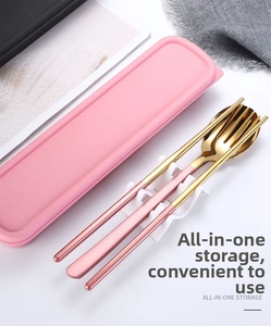 Close-up of pink and gold stainless steel cutlery set with storage box and wavy holder