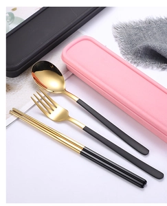 Close-up of portable 304 stainless steel cutlery set with gold finish and black handles
