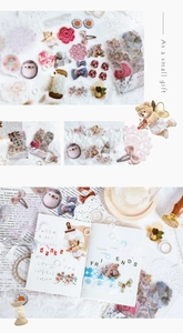 Detail of PET stickers featuring vintage floral and teddy bear designs on scrapbook pages