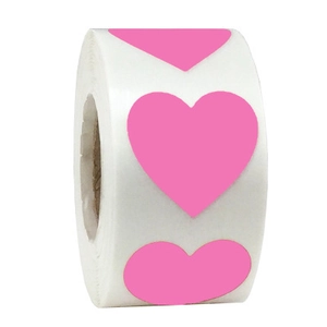 Close-up of pink heart-shaped adhesive stickers roll for gift wrapping and decoration