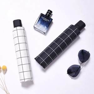 Classic checkered folding sun umbrellas in black and white with matching storage covers