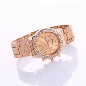 Rose gold Geneva women's watch with rhinestone bezel and metal link bracelet on white surface