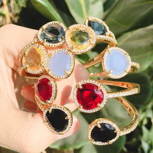 Minimalist gold bangles set with geometric colorful crystals and white zircon accents