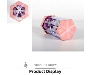 Detail of purple Christmas ornament gift set in hexagonal box with a white tulle bow