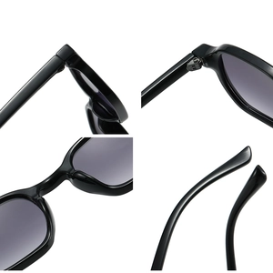 Black fashion sunglasses with grey gradient lenses and detailed metal hinges