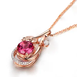 Macro view of rose gold pendant featuring round pink gemstone and pavé diamonds detail