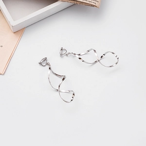Minimalist spiral twisted earrings in bright silver finish shown from a top-down view