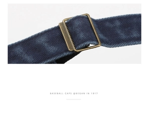 Detailed close-up of blue corduroy baseball cap with adjustable bronze metal buckle strap