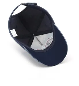 Detailed interior of blue washed denim baseball cap featuring cotton label and sweatband