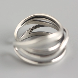 Detailed macro view of S925 sterling silver stamp on minimalist layered irregular ring